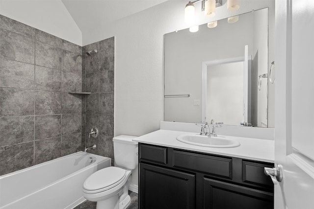 full bathroom with toilet, vanity, lofted ceiling, and tiled shower / bath