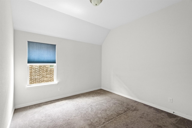 unfurnished room with lofted ceiling and carpet floors