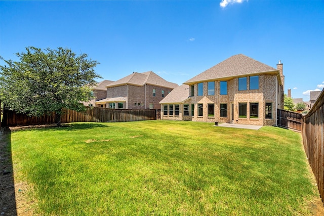 back of property with a patio and a lawn