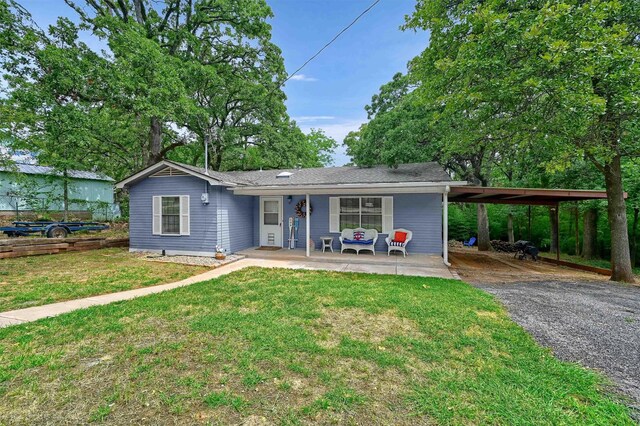 view of front of house featuring a carport, a porch, and a front yard