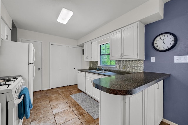 kitchen with tasteful backsplash, white cabinetry, sink, kitchen peninsula, and white appliances