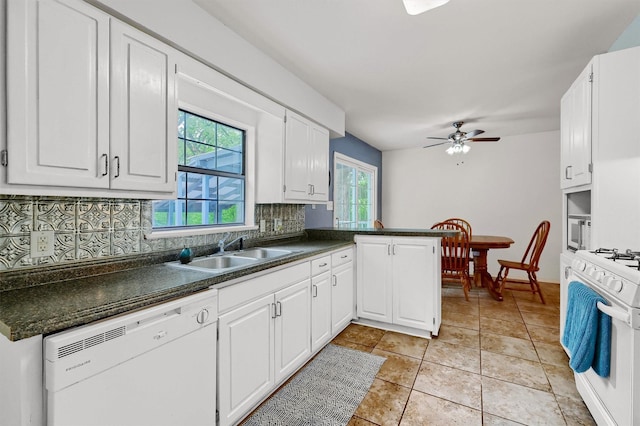 kitchen with sink, white cabinetry, kitchen peninsula, white appliances, and backsplash