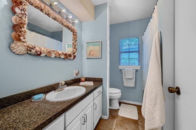 bathroom featuring vanity, tile patterned flooring, and toilet