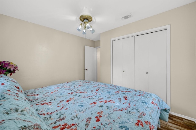 bedroom featuring hardwood / wood-style floors and a closet