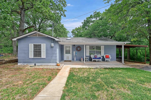 single story home with a front lawn and a carport