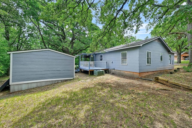 back of property featuring a wooden deck and central air condition unit