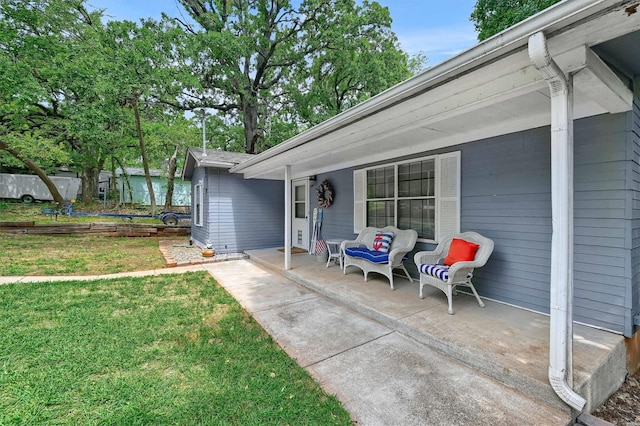 property entrance with a yard and a patio area