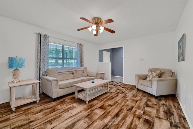 living room with hardwood / wood-style floors and ceiling fan