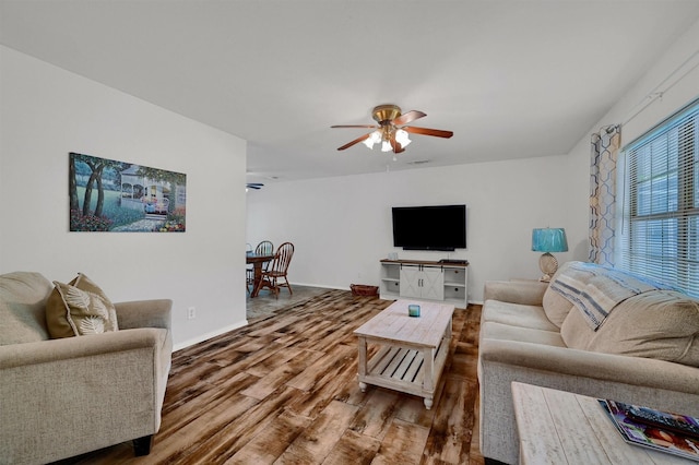 living room with hardwood / wood-style flooring and ceiling fan