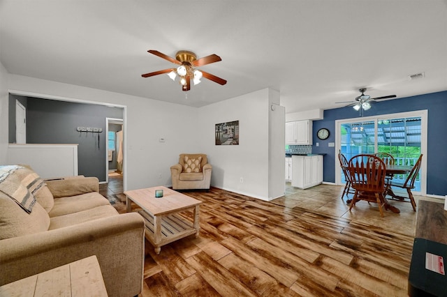 living room with hardwood / wood-style flooring and ceiling fan