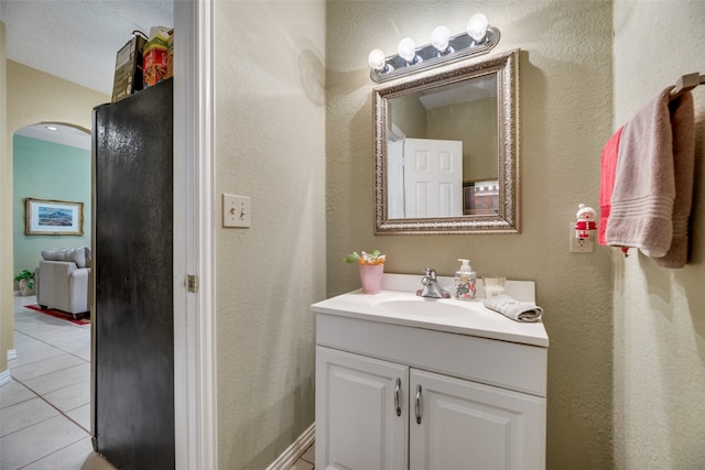 bathroom featuring vanity, a textured ceiling, and tile patterned floors