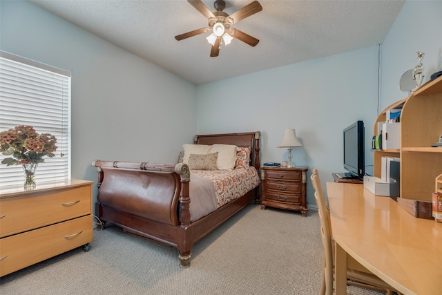 bedroom with carpet flooring, a textured ceiling, and ceiling fan