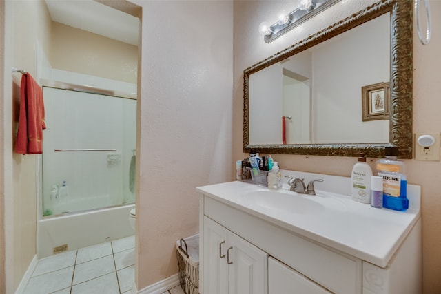 full bathroom with tile patterned floors, vanity, bath / shower combo with glass door, and toilet