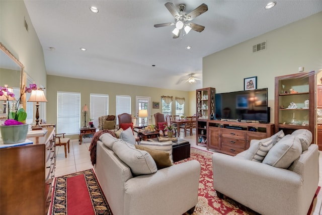 tiled living room featuring a textured ceiling and ceiling fan