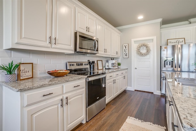 kitchen with white cabinetry, stainless steel appliances, ornamental molding, dark hardwood / wood-style floors, and backsplash