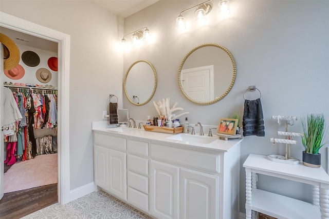 bathroom featuring hardwood / wood-style floors and dual bowl vanity