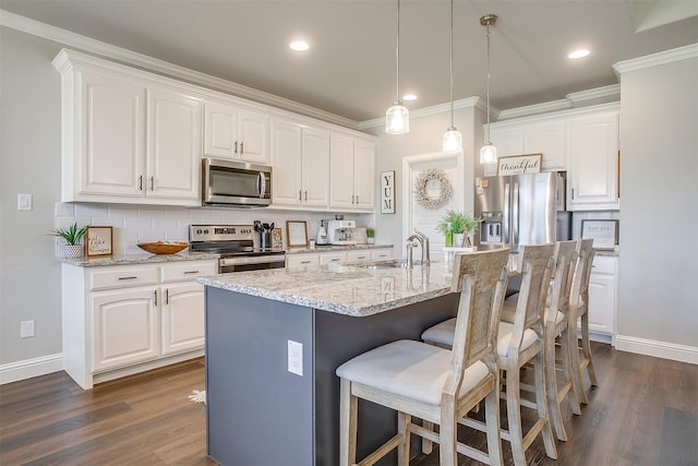 kitchen with stainless steel appliances, white cabinets, sink, a center island with sink, and dark wood-type flooring