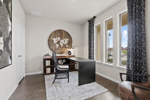 home office with dark hardwood / wood-style floors