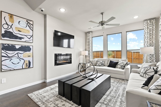 living room featuring dark hardwood / wood-style floors and ceiling fan