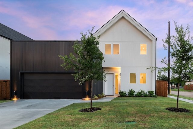 modern home featuring a garage and a lawn