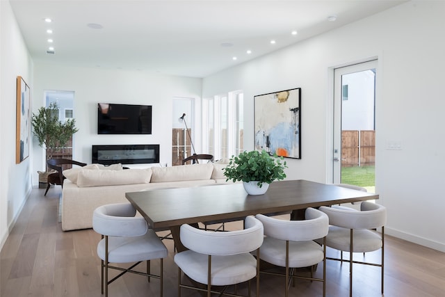 dining space with hardwood / wood-style floors