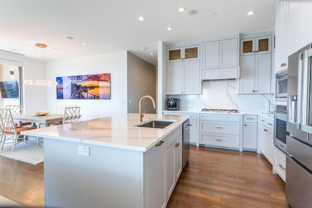 kitchen with sink, an island with sink, and white cabinetry