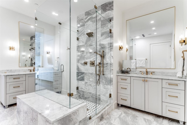 bathroom featuring a shower with shower door and vanity