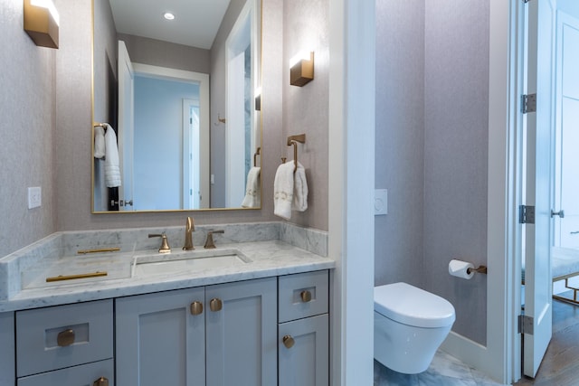 bathroom featuring toilet and vanity