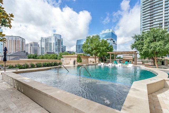 view of pool with a patio and a pergola