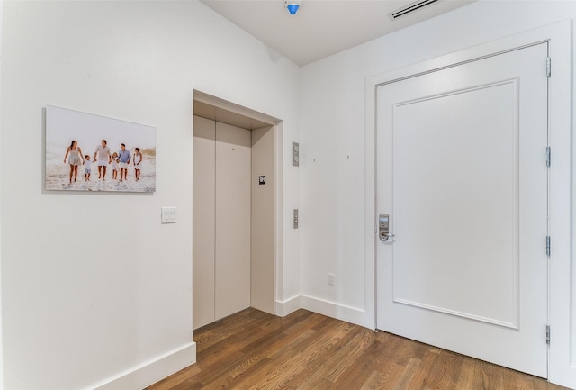 interior space with elevator and dark hardwood / wood-style floors