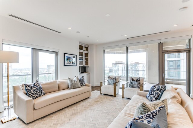 living room featuring a wealth of natural light and light hardwood / wood-style flooring