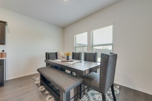 dining space with dark wood-type flooring