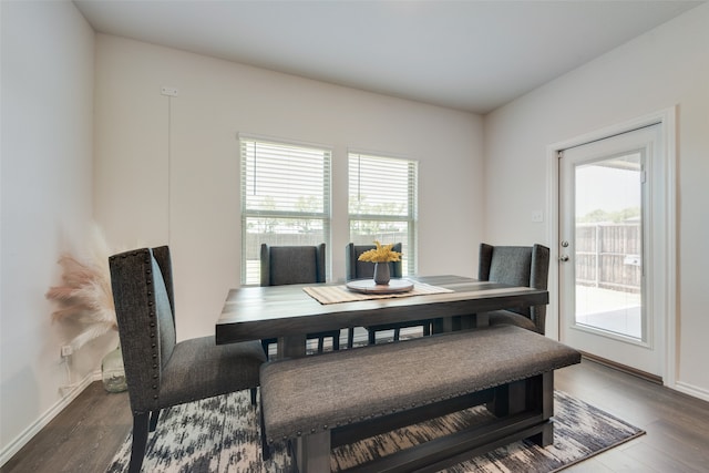 dining area with a wealth of natural light and hardwood / wood-style flooring