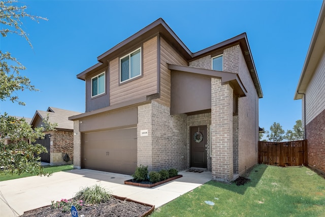 view of front of home featuring a garage and a front yard