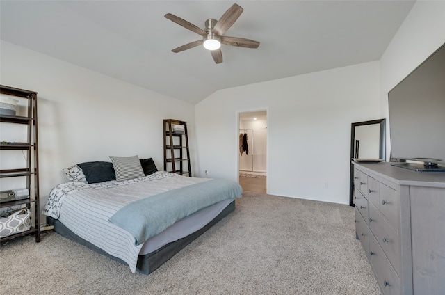 carpeted bedroom with ensuite bathroom, ceiling fan, and lofted ceiling