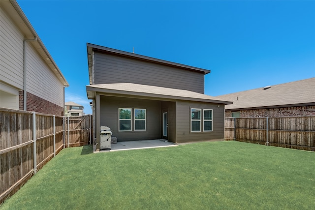 rear view of property with a patio and a yard