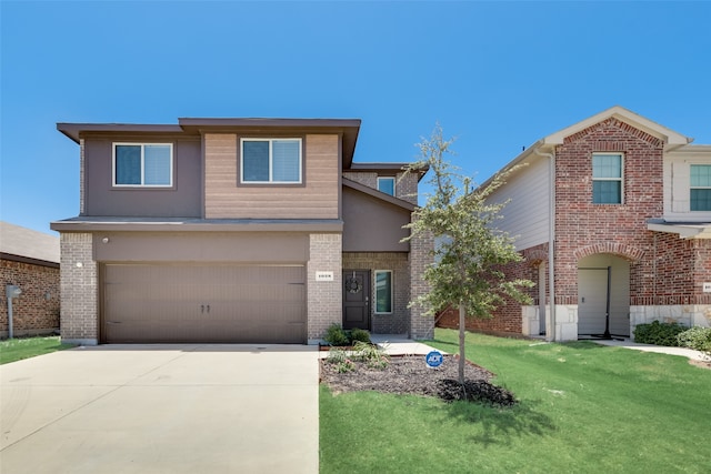 view of front of house featuring a garage and a front yard