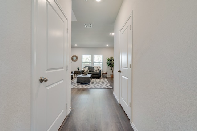 corridor with dark hardwood / wood-style flooring