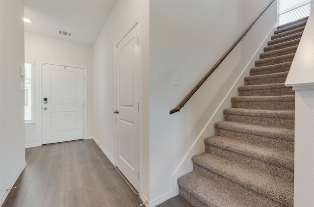 staircase featuring hardwood / wood-style flooring