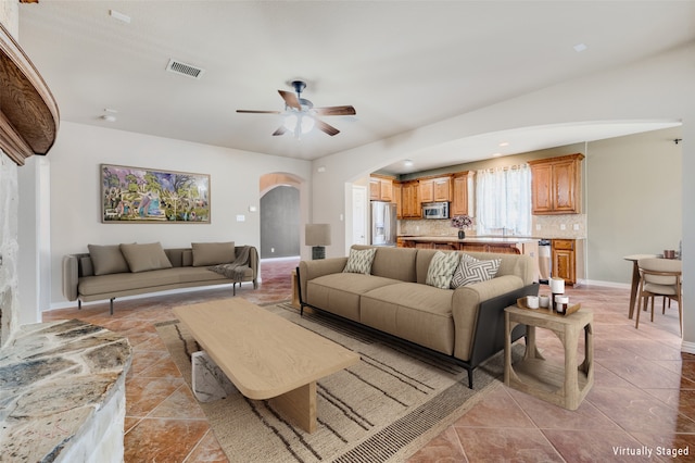 living room featuring light tile patterned floors and ceiling fan