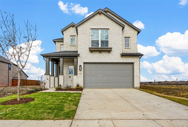 view of front of home featuring a garage, a front yard, and covered porch