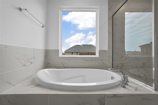 bathroom featuring tiled bath