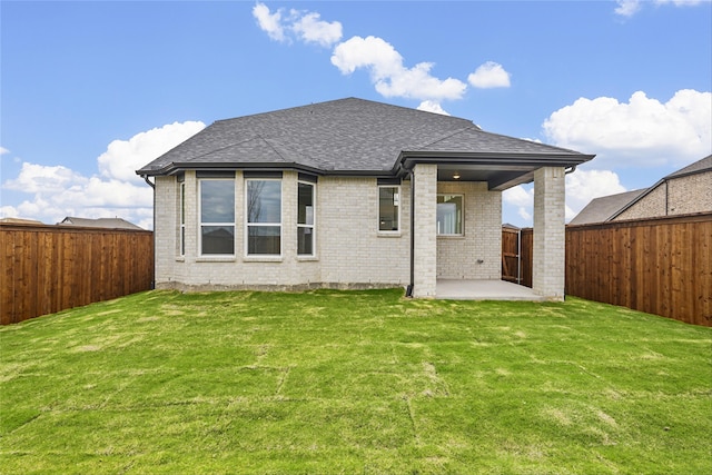 rear view of property with a patio area and a lawn