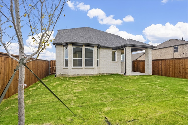 back of house featuring a patio and a lawn