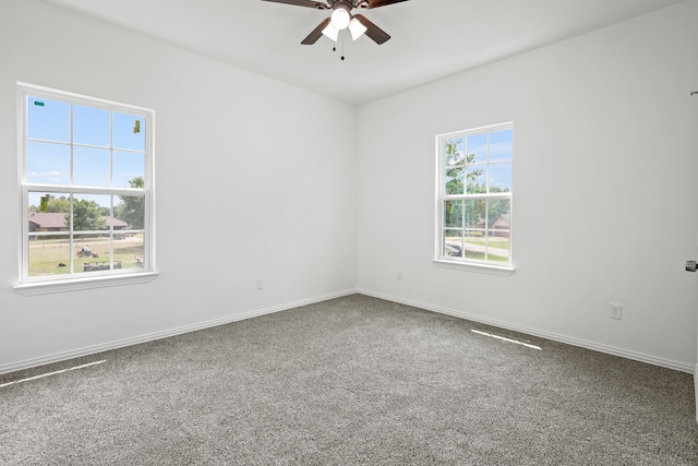 empty room featuring ceiling fan and carpet floors