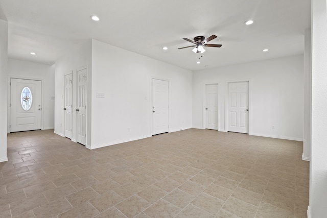 interior space with ceiling fan