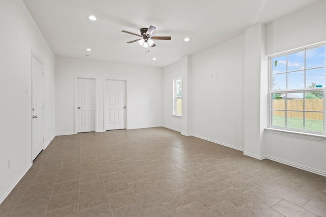 unfurnished room with plenty of natural light and ceiling fan