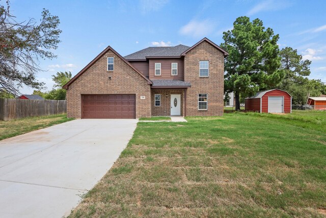 view of front of house featuring a garage and a front lawn