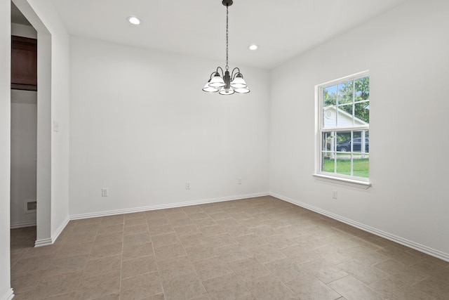 empty room with a notable chandelier