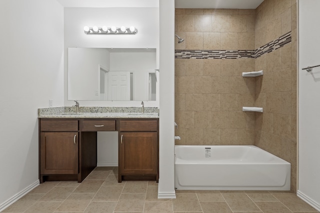 bathroom with tile patterned floors, vanity, and tiled shower / bath